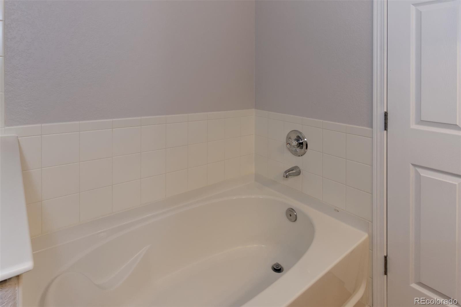 8440 Canyon Rim Trail, Unit 4 Parker, CO 80134 - Photo 16 of 28 a close up of a bathtub