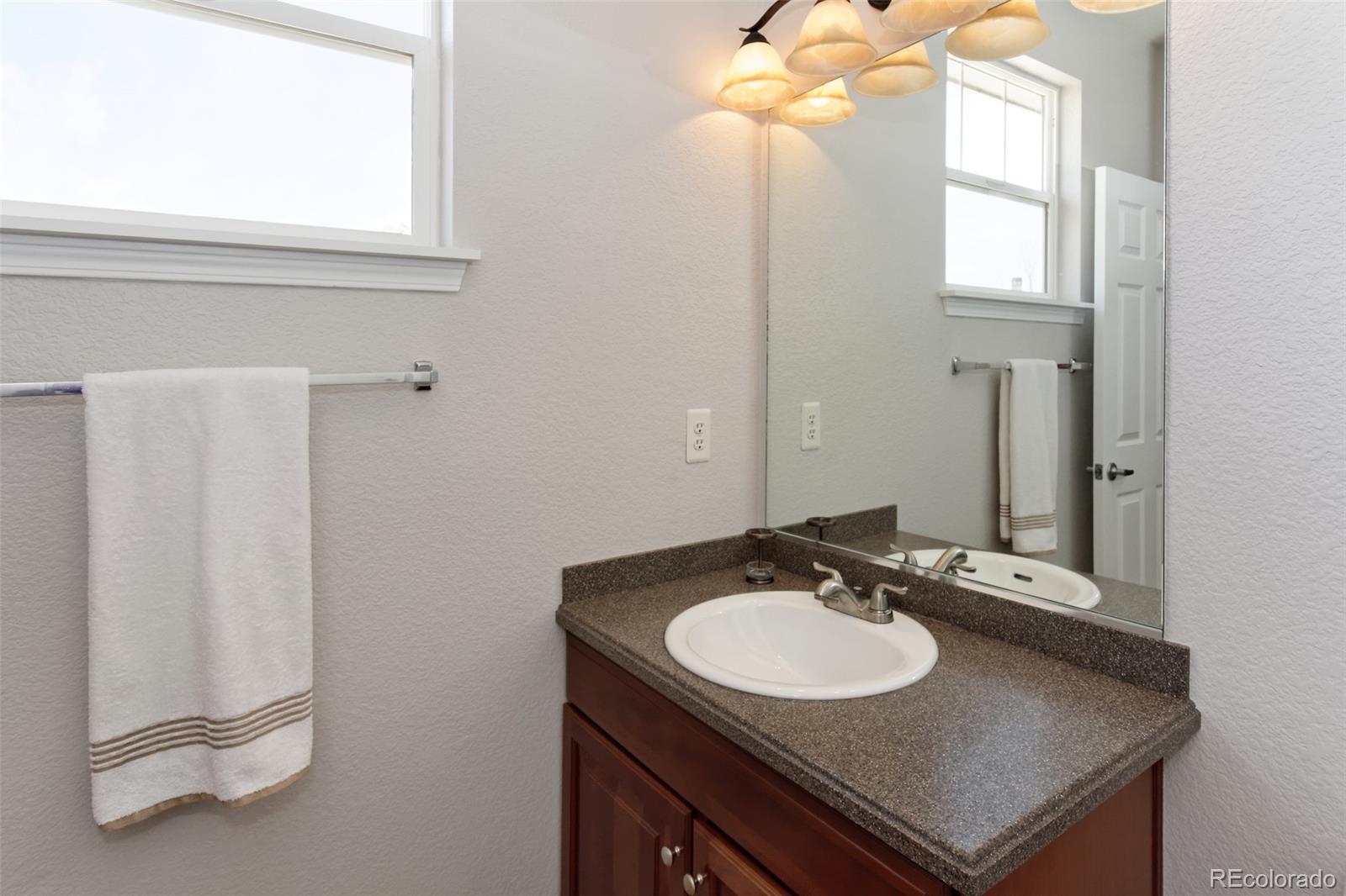 8440 Canyon Rim Trail, Unit 4 Parker, CO 80134 - Photo 24 of 28 a bathroom with a sink and a mirror