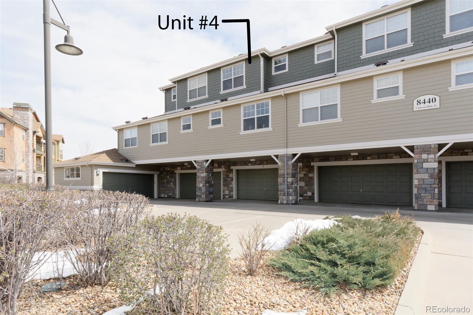 8440 Canyon Rim Trail, Unit 4 Parker, CO 80134 - Photo 27 of 28 a front view of a house with yard and garage