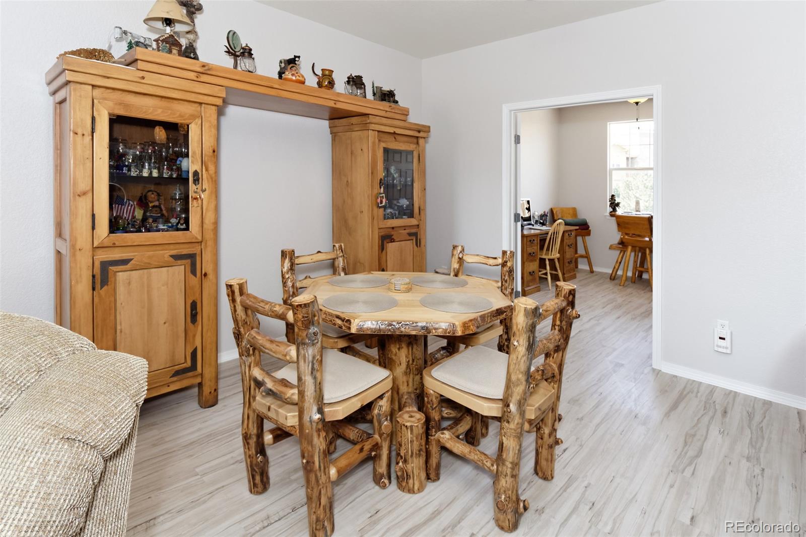 8440 Canyon Rim Trail, Unit 4 Parker, CO 80134 - Photo 6 of 28 a view of a dining room with furniture and wooden floor