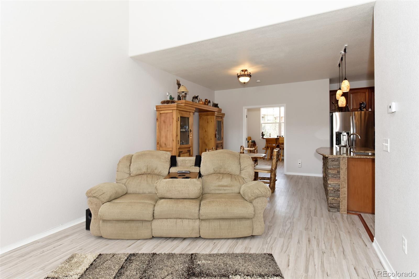 8440 Canyon Rim Trail, Unit 4 Parker, CO 80134 - Photo 8 of 28 a living room with furniture and a wooden floor