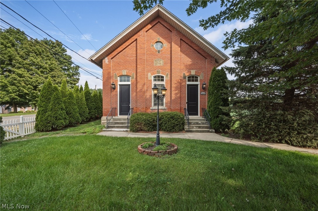 42764 Russia Road Elyria, OH 44035 - Photo 10 of 50 Red brick exterior with arched windows and a central street lamp
