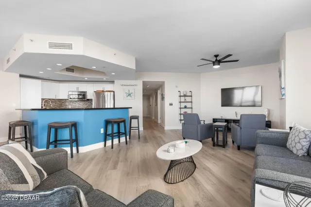 an aerial view of a house with a garden and lake view