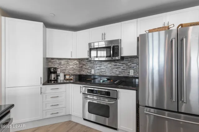a living room with furniture and a book shelf