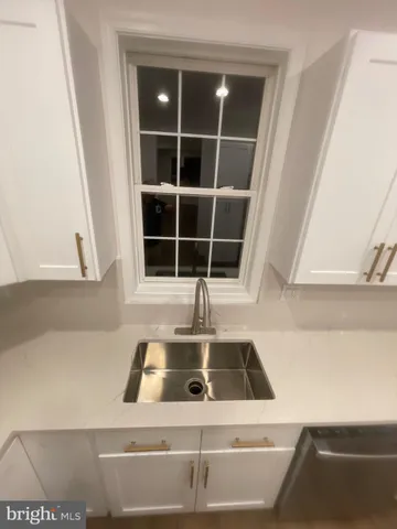 a view of a hallway with wooden floor and entryway