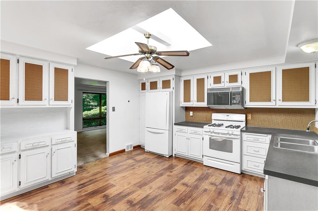 937 MacBeth Drive Monroeville, PA 15146 - Photo 14 of 25 a kitchen with stainless steel appliances granite countertop a stove and a refrigerator