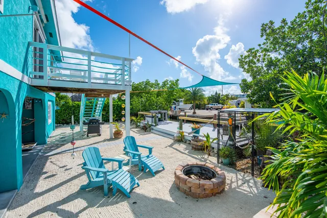 a view of a patio with couches table and chairs and potted plants