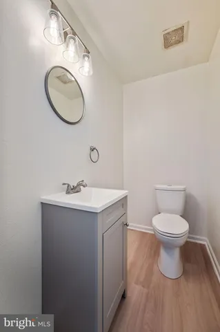 a bathroom with a toilet a sink and mirror