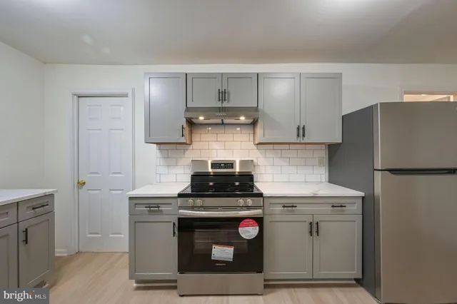 a kitchen with a stove and a refrigerator