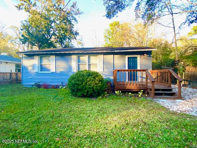 a view of a house with a yard and sitting area