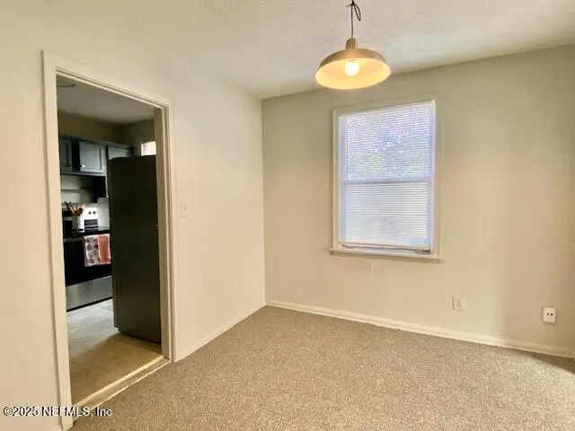 a view of a backyard with large trees