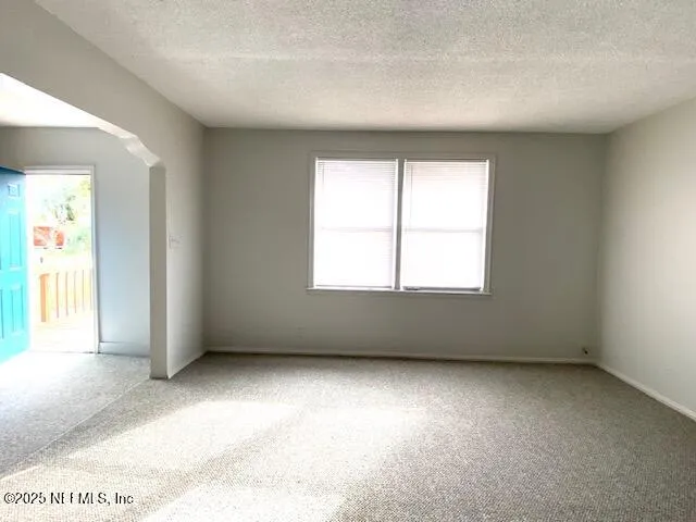 a view of a backyard with large trees