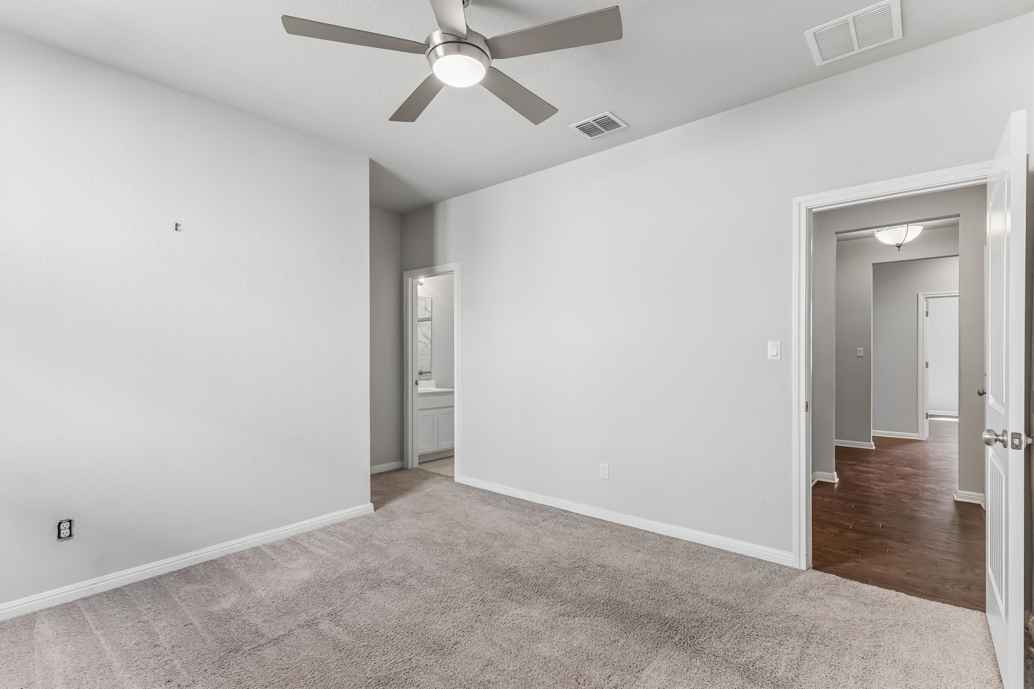 4009 Milano River Road Hutto, TX 78634 - Photo 25 of 40 Soft carpeting underfoot anchors this quiet space with direct access to a private bathroom.