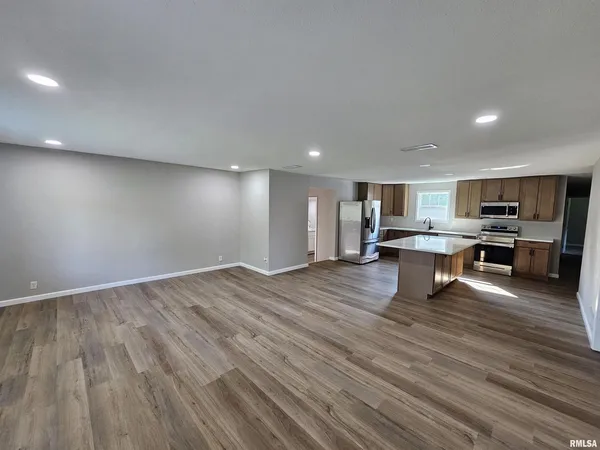 a view of kitchen with wooden floor
