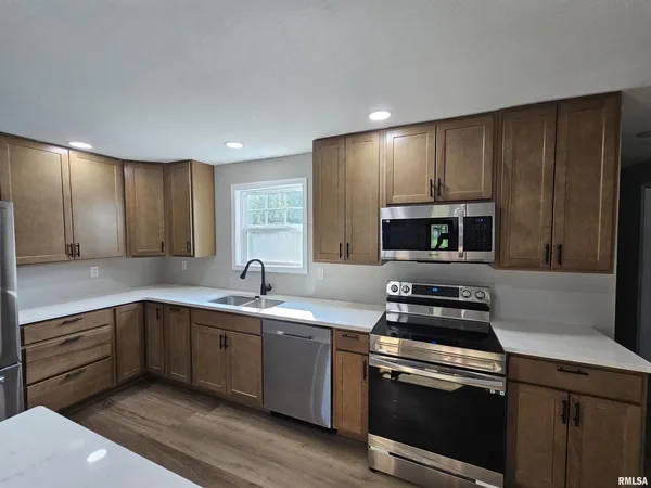 a kitchen with appliances cabinets and a sink