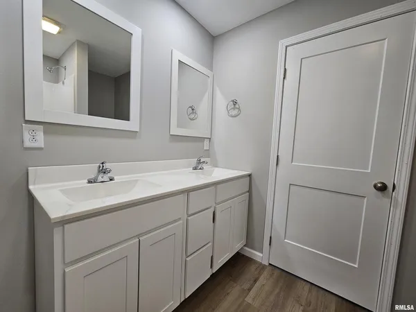 a bathroom with a double vanity sink and mirror