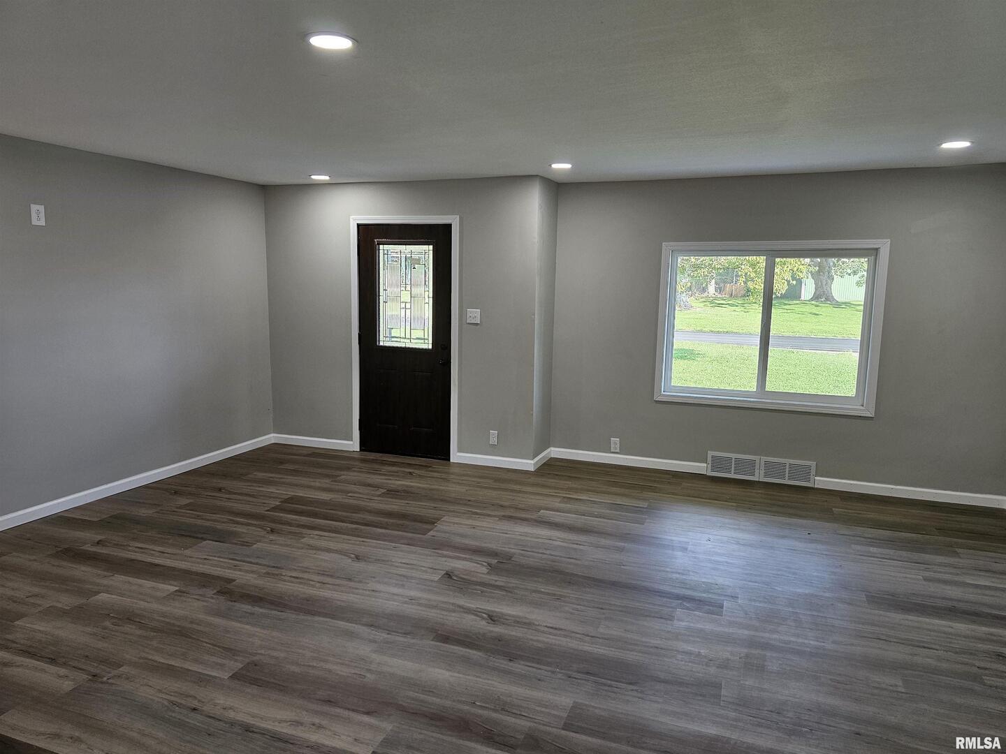 16530 East Fairfield Road Mount Vernon, IL 62864 - Photo 9 of 28 an empty room with wooden floor and windows
