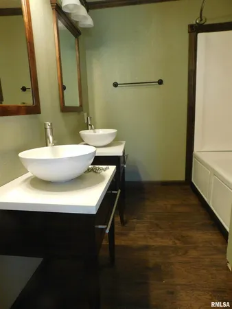 a bathroom with a sink a mirror and a toilet