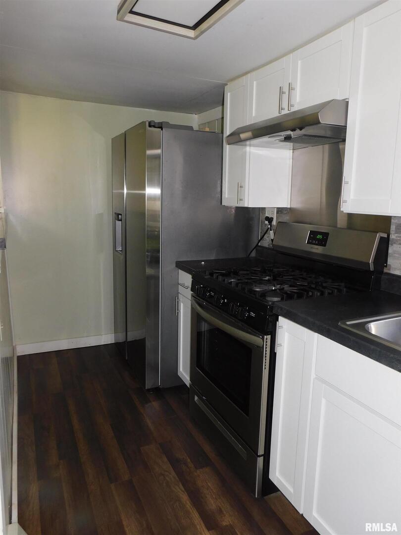 2517 Highway 17 Viola, IL 61486 - Photo 15 of 25 a kitchen with stainless steel appliances granite countertop a stove and a refrigerator