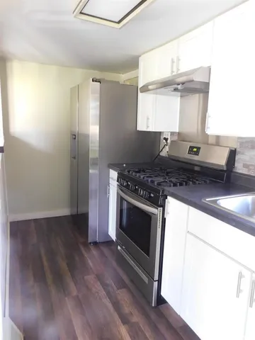 a kitchen with stainless steel appliances granite countertop a stove and a sink