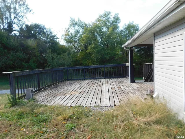 a view of backyard with wooden deck and floor