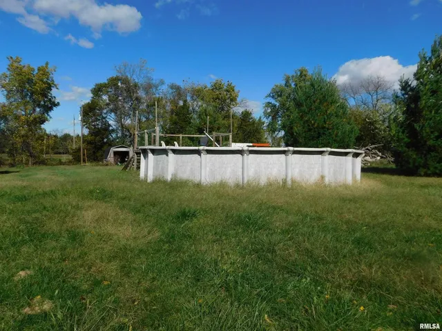 a view of a backyard with large trees