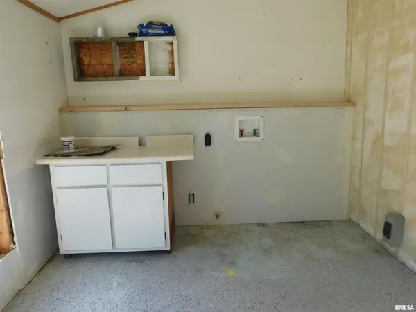 a utility room with a sink a vanity and a mirror