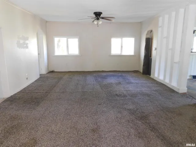 an empty room that has a window in it