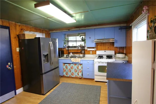 a kitchen with refrigerator and cabinets