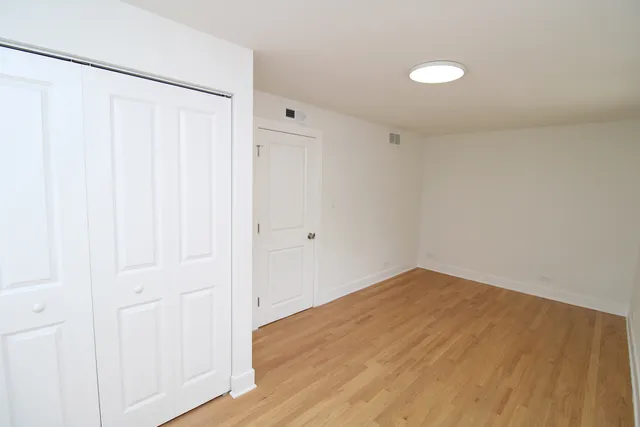 a view of a room with wooden floor