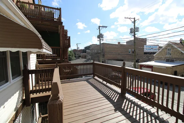 a view of a balcony with wooden floor