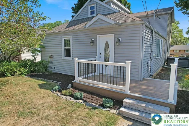a view of a chairs and table in the backyard