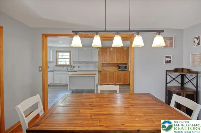 a kitchen with a refrigerator a sink dishwasher and wooden cabinets with wooden floor