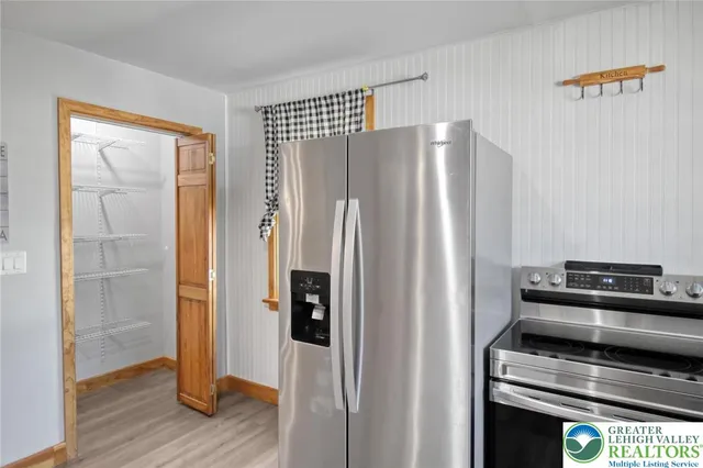 a view of a workspace with furniture and wooden floor