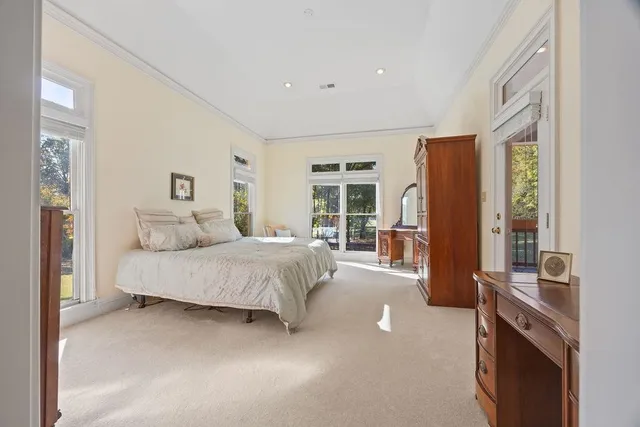 a spacious bedroom with a large bed and a balcony