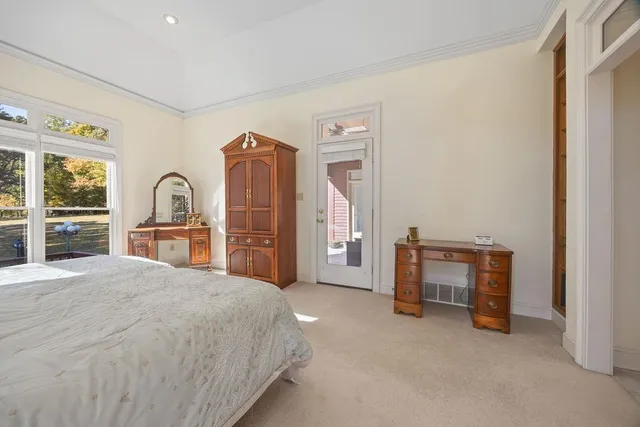 a spacious bedroom with a bed and a desk