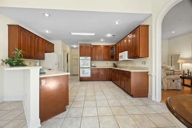 a kitchen with stainless steel appliances granite countertop a refrigerator sink and cabinets
