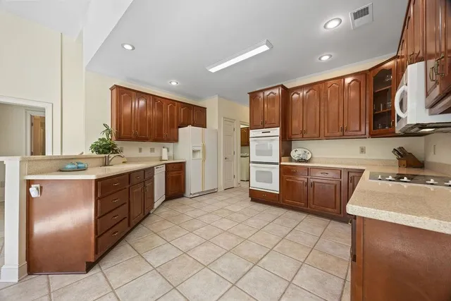 a kitchen with a refrigerator sink and cabinets