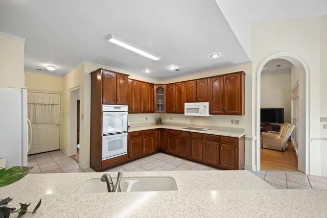 a kitchen with stainless steel appliances granite countertop a refrigerator and a sink