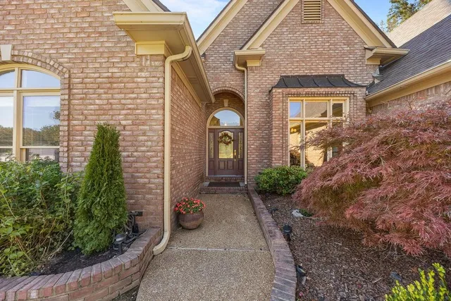 a front view of a house with garden