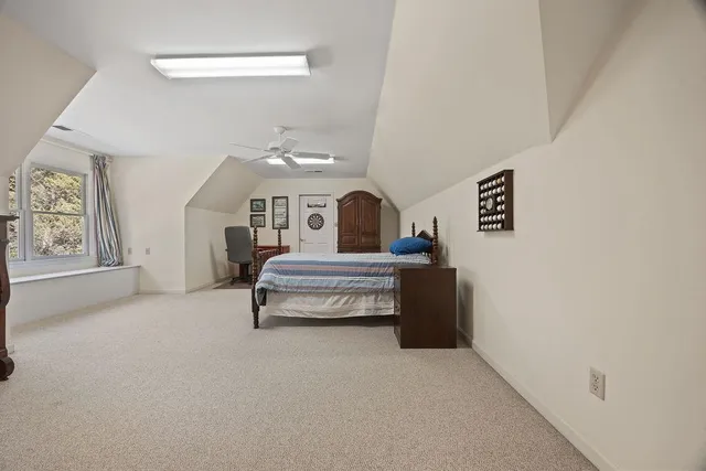 a bedroom with furniture and a window