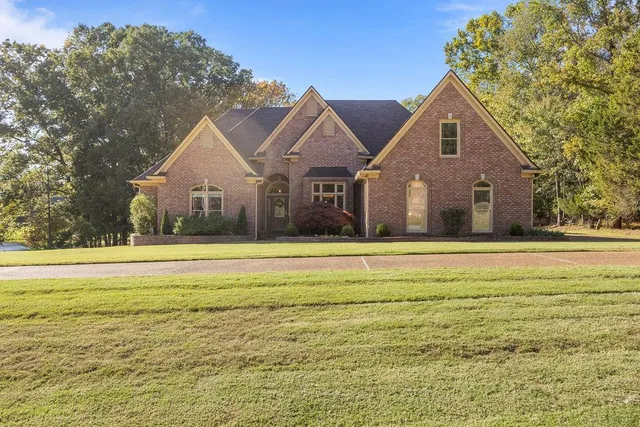 a front view of house with yard and green space