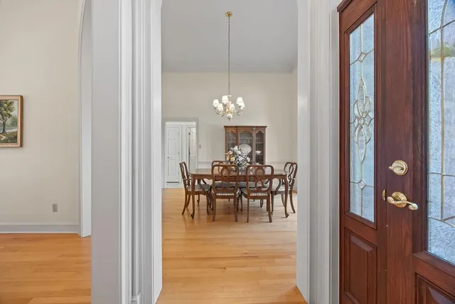 a view of a dining room with furniture and chandelier