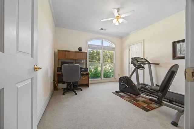 a view of a workspace with furniture and a window