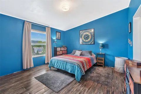 a bedroom with a large bed and a window