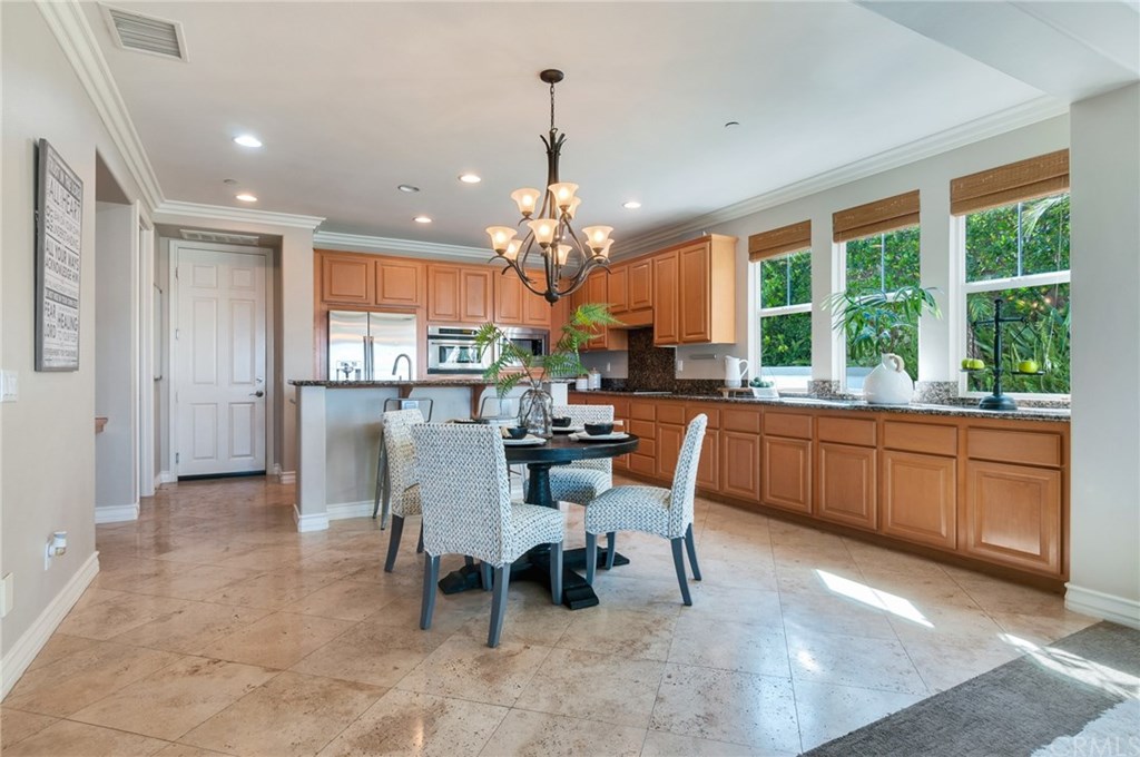 2470 Bulrush Circle Corona, CA 92882 - Photo 13 of 64 a kitchen with a dining table chairs appliances and cabinets