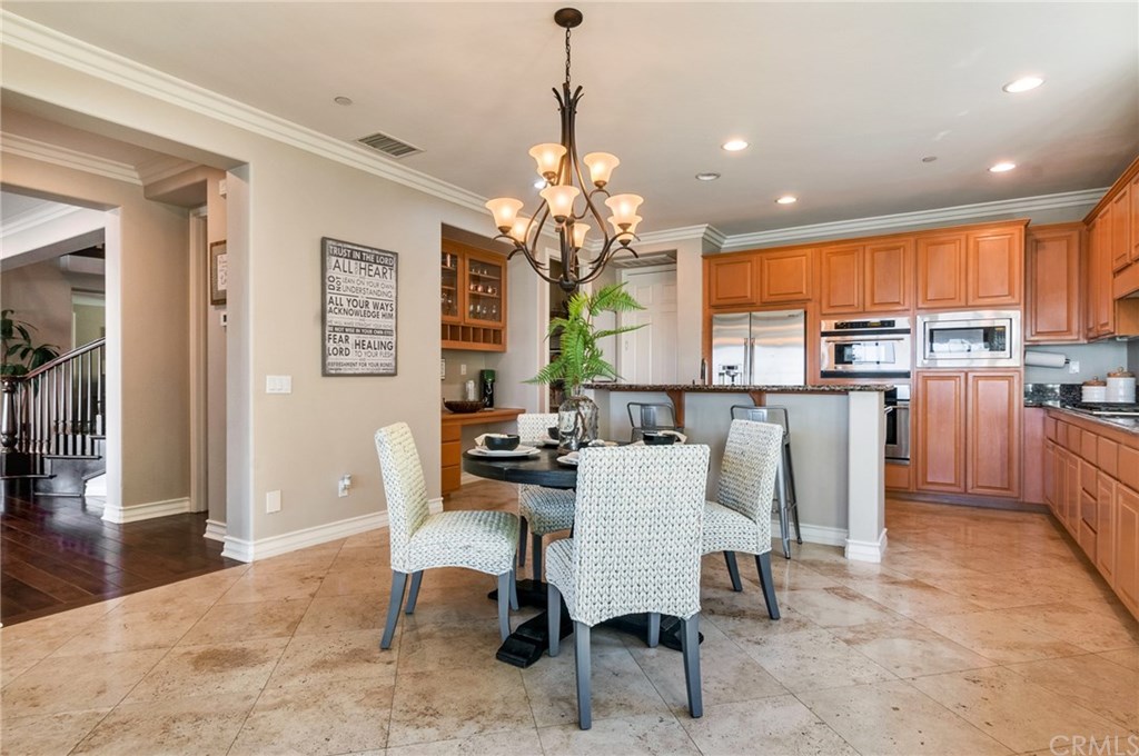 2470 Bulrush Circle Corona, CA 92882 - Photo 57 of 64 a dining room filled with furniture and a chandelier