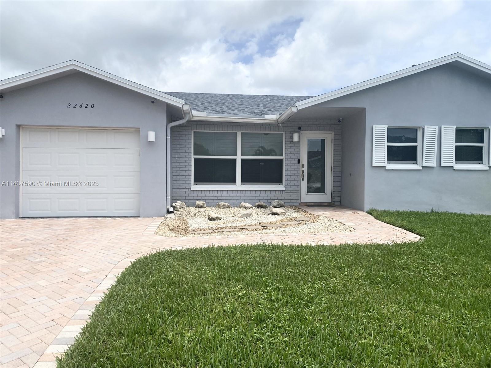 22620 Southwest 65th Way Boca Raton, FL 33428 - Photo 1 of 23 a view of a house with a yard and garage
