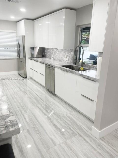 22620 Southwest 65th Way Boca Raton, FL 33428 - Photo 11 of 23 a kitchen with a sink stove and refrigerator