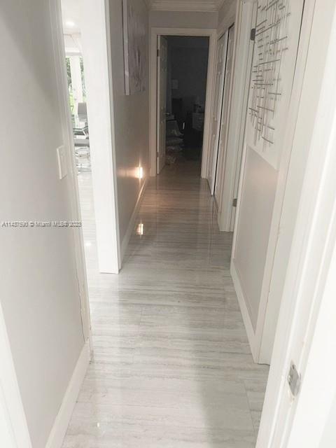 22620 Southwest 65th Way Boca Raton, FL 33428 - Photo 12 of 23 a view of a hallway with wooden floor and staircase